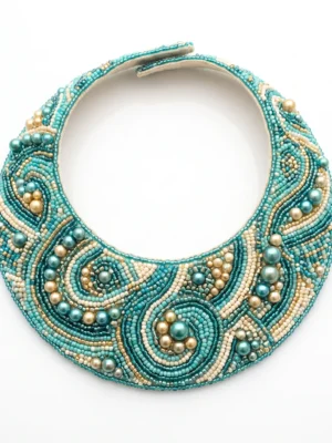 Aqua blue hand beaded collar with pearl beads, metallic gold accents and intricate swirling patterns for couture fashion and designer garments.
