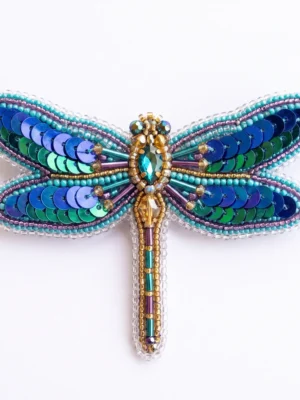 Blue dragonfly hand beaded brooch with turquoise seed beads, blue and green sequins, metallic bugle beads and faceted crystal embellishments.