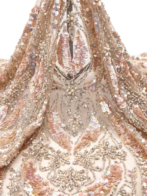 Blush Sequin Floral Beaded Fabric Blush sequin beaded fabric with iridescent leaf motifs, crystal floral embroidery and pearl embellishments on sheer mesh.