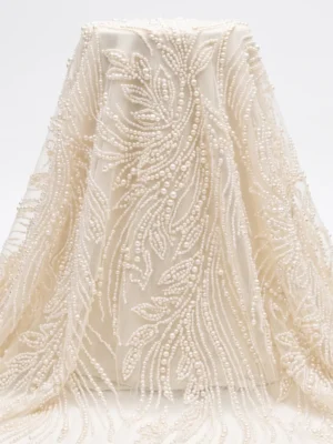Botanical Pearl Beaded Fabric Ivory pearl beaded fabric with flowing botanical leaf embroidery handcrafted on sheer mesh for bridal gowns and couture dresses.