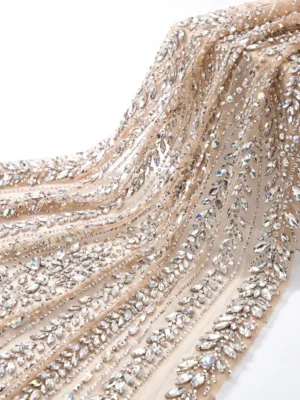 Champagne Leaf Crystal Beaded Fabric Champagne crystal beaded fabric with cascading leaf motifs, clear faceted stones and intricate hand embellished detailing.