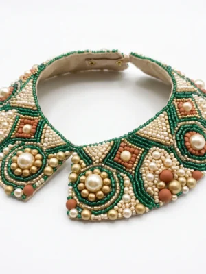 Emerald Green Pearl Hand Beaded Collar Emerald green and ivory hand beaded collar with pearl embellishments, gold beads and geometric motifs for couture fashion.