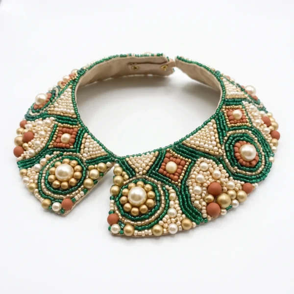 Emerald Green Pearl Hand Beaded Collar Emerald green and ivory hand beaded collar with pearl embellishments, gold beads and geometric motifs for couture fashion.