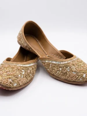 Golden Floral Hand Beaded Jutti Golden hand beaded jutti with floral embroidery, metallic beads and sequin embellishments.