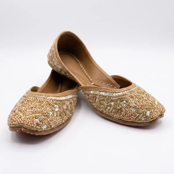 Golden Floral Hand Beaded Jutti Golden hand beaded jutti with floral embroidery, metallic beads and sequin embellishments.