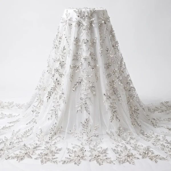 Ivory Crystal & Pearl Bridal Beaded Fabric Ivory bridal beaded fabric with silver crystals, pearls and hand embellished floral motifs on sheer tulle.