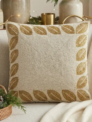 Ivory hand beaded pillow with gold leaf border design