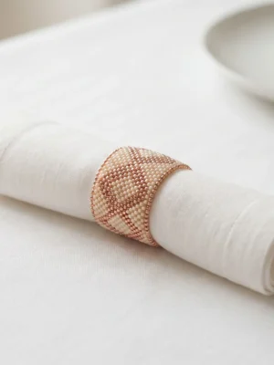Ivory and rose gold hand beaded napkin ring with geometric pattern