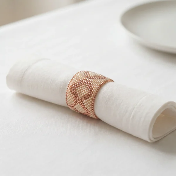 Ivory and rose gold hand beaded napkin ring with geometric pattern