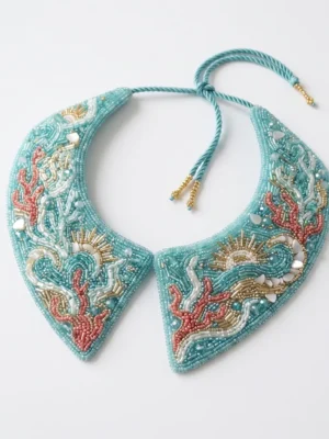 Ocean Coral Hand Beaded Collar Aqua blue hand beaded collar with coral, wave, shell and sun motifs in pink, white and gold bead embroidery.