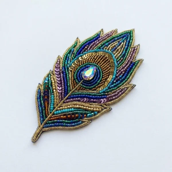Peacock Feather Hand Beaded Patch Peacock feather beaded patch manufacturer & exporter for fashion brands and wholesalers. Custom hand beaded patches for OEM, private label and bulk orders.