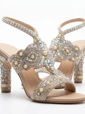 Pearl and crystal hand beaded block heel sandals with embellished straps and ankle fastening.