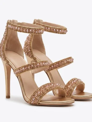 Rose gold hand beaded stiletto sandals with crystal embellished straps and high heels.