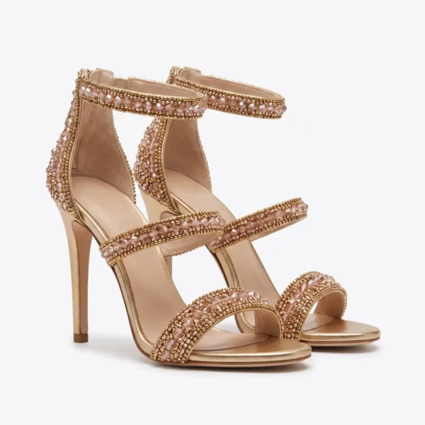 Rose Gold Crystal Hand Beaded Stiletto Sandals Rose gold hand beaded stiletto sandals with crystal embellished straps and high heels.