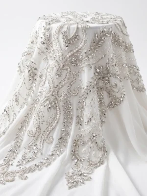 Silver Crystal & Pearl Bridal Beaded Fabric White bridal beaded fabric with silver crystals, pearls and flowing hand embellished botanical vine motifs.