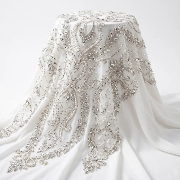 Silver Crystal & Pearl Bridal Beaded Fabric White bridal beaded fabric with silver crystals, pearls and flowing hand embellished botanical vine motifs.