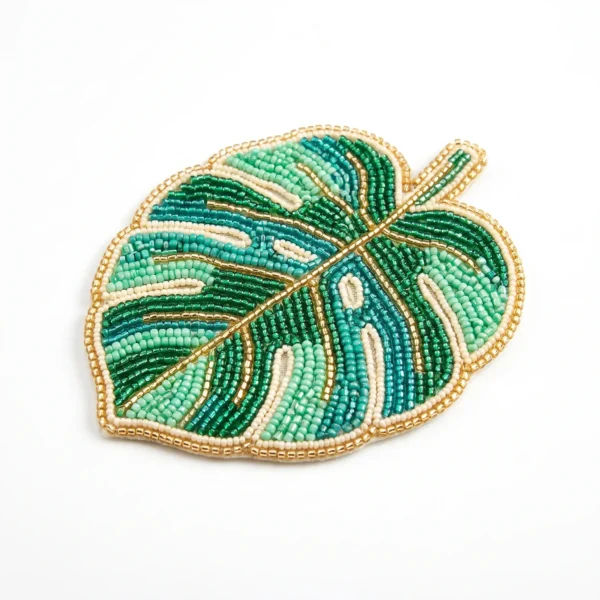 Tropical monstera leaf hand beaded patch with green, turquoise, mint and ivory seed beads finished with metallic gold bead detailing.