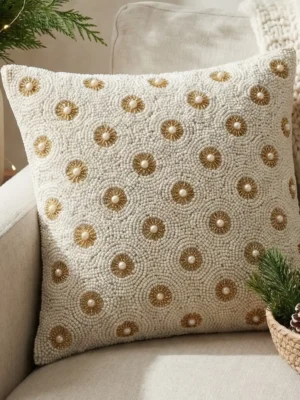 White hand beaded pillow with gold circular motifs and pearl accents